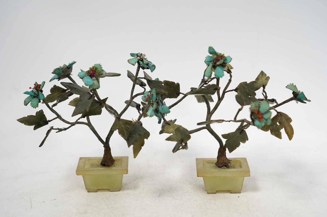 Two pairs of Chinese jade and hardstone mounted models of trees, tallest 16cm. Condition - fair, some losses